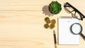 Business Workplace Desk with Notepad, Coins, Glasses, and Magnifying Glass for Financial Analysis Royalty Free Stock Photo
