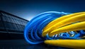 Close-up of tangled blue and yellow network cables on a dark background Royalty Free Stock Photo