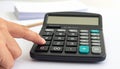 Close-up of a Finger Pressing a Button on a Calculator Royalty Free Stock Photo