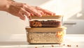 Hands Closing Stacked Food Storage Containers with Grains and Legumes Royalty Free Stock Photo
