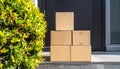 Delivery Boxes Stacked on Porch by Green Bush Royalty Free Stock Photo