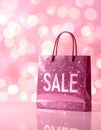 Abstract Pink Bokeh Background with Sparkling SALE Text and Glossy Gift Bag Royalty Free Stock Photo