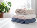 Freshly colored towels on the white table at home, shut up. Text area Royalty Free Stock Photo