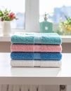 Freshly colored towels on the white table at home, shut up. Text area Royalty Free Stock Photo