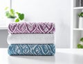 Freshly colored towels on the white table at home, shut up. Text area Royalty Free Stock Photo
