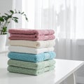 Freshly colored towels on the white table at home, shut up. Text area Royalty Free Stock Photo