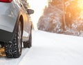Modern car with winter tires on snowy road Royalty Free Stock Photo