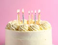 Delicious cake with cream burning candles on color background, closeup Royalty Free Stock Photo