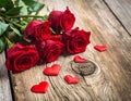 Red roses with hearts on a old wooden table, valentines day Royalty Free Stock Photo
