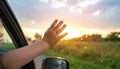 A close-up of a hand reaching out from a car window, with raindrops on the glass. Royalty Free Stock Photo