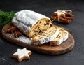 Christmas stollen with gingerbread on the black background texture. Royalty Free Stock Photo