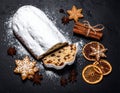 Christmas stollen with gingerbread on the black background texture. Royalty Free Stock Photo
