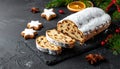 Christmas stollen with gingerbread on the black background texture. Royalty Free Stock Photo