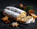 Christmas stollen with gingerbread on the black background texture. Royalty Free Stock Photo
