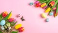 Easter eggs and beautiful tulips on a pink background, flat flag. Text area Royalty Free Stock Photo