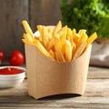 Delicious french fries in paper box on wooden table, space for text Royalty Free Stock Photo