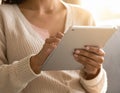 Close-up photo of female hands working with tablet computer. Woman using social network Royalty Free Stock Photo