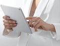Close-up photo of female hands working with tablet computer. Woman using social network Royalty Free Stock Photo