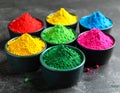 Colorful powder dyes on grey background, closeup. Holi festival Royalty Free Stock Photo