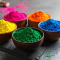 Colorful powder dyes on grey background, closeup. Holi festival Royalty Free Stock Photo