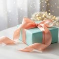 A light blue gift box wrapped with a wide, glossy peach satin ribbon Royalty Free Stock Photo