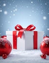 Winter Festive Design. White gift box decorated with a red bow in surrounding by glos Royalty Free Stock Photo