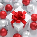 Winter Festive Design. White gift box decorated with a red bow in surrounding by glos Royalty Free Stock Photo
