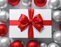 Winter Festive Design. White gift box decorated with a red bow in surrounding by glos Royalty Free Stock Photo