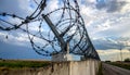 Barbed wire fencing on a sky background. Close up Royalty Free Stock Photo