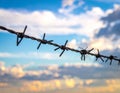 Barbed wire fencing on a sky background. Close up Royalty Free Stock Photo