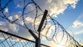 Barbed wire fencing on a sky background. Close up Royalty Free Stock Photo