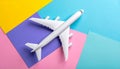 Passenger jet airplane, minimal concept, on funny colors paper with geometric shapes. Royalty Free Stock Photo