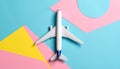 Passenger jet airplane, minimal concept, on funny colors paper with geometric shapes. Royalty Free Stock Photo