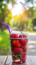 Soft Focus Strawberry in plastic cup in a park.- (Selective focus) Royalty Free Stock Photo