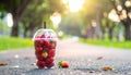 Soft Focus Strawberry in plastic cup in a park.- (Selective focus) Royalty Free Stock Photo