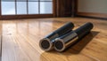 Two Black and Silver Cylindrical Objects on Wooden Floor Royalty Free Stock Photo