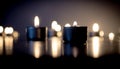Serene Tealight Candles Burning in Darkness with Reflections Royalty Free Stock Photo