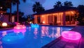 Luxury Tropical Villa Poolside at Dusk with Inflatables Royalty Free Stock Photo
