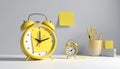 Yellow Alarm Clocks and Stationery on a Desk Royalty Free Stock Photo