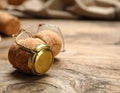 Cork of sparkling wine and muselet cap on wooden table, closeup. Space for text Royalty Free Stock Photo