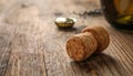 Cork of sparkling wine and muselet cap on wooden table, closeup. Space for text Royalty Free Stock Photo