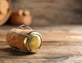 Cork of sparkling wine and muselet cap on wooden table, closeup. Space for text Royalty Free Stock Photo