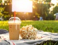 Popcorn and drink on blanket in open air cinema. Space for text Royalty Free Stock Photo
