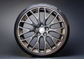 Modern alloy wheel with a sleek, multi-spoke design, featuring polished metal with a reflective finish. Royalty Free Stock Photo