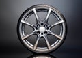 Modern alloy wheel with a sleek, multi-spoke design, featuring polished metal with a reflective finish. Royalty Free Stock Photo
