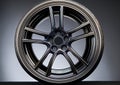 Modern alloy wheel with a sleek, multi-spoke design, featuring polished metal with a reflective finish. Royalty Free Stock Photo