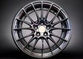 Modern alloy wheel with a sleek, multi-spoke design, featuring polished metal with a reflective finish. Royalty Free Stock Photo