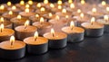 Many candle flames glowing on dark background. Close-up. Free space. Royalty Free Stock Photo