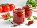 Jars of tasty tomato paste, spoon and ingredients on white table Royalty Free Stock Photo