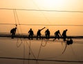Silhouette of Electrical Workers on Power Lines Royalty Free Stock Photo